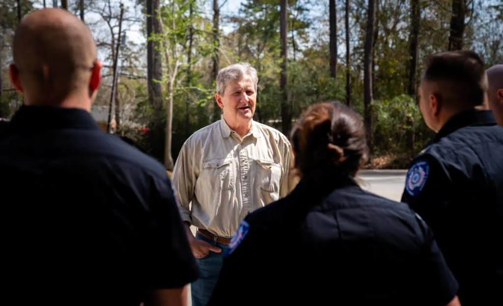 John Kennedy speaks with police officers at community event.